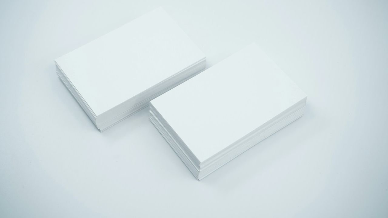 Two matching blank business cards, representing consistent business listings
