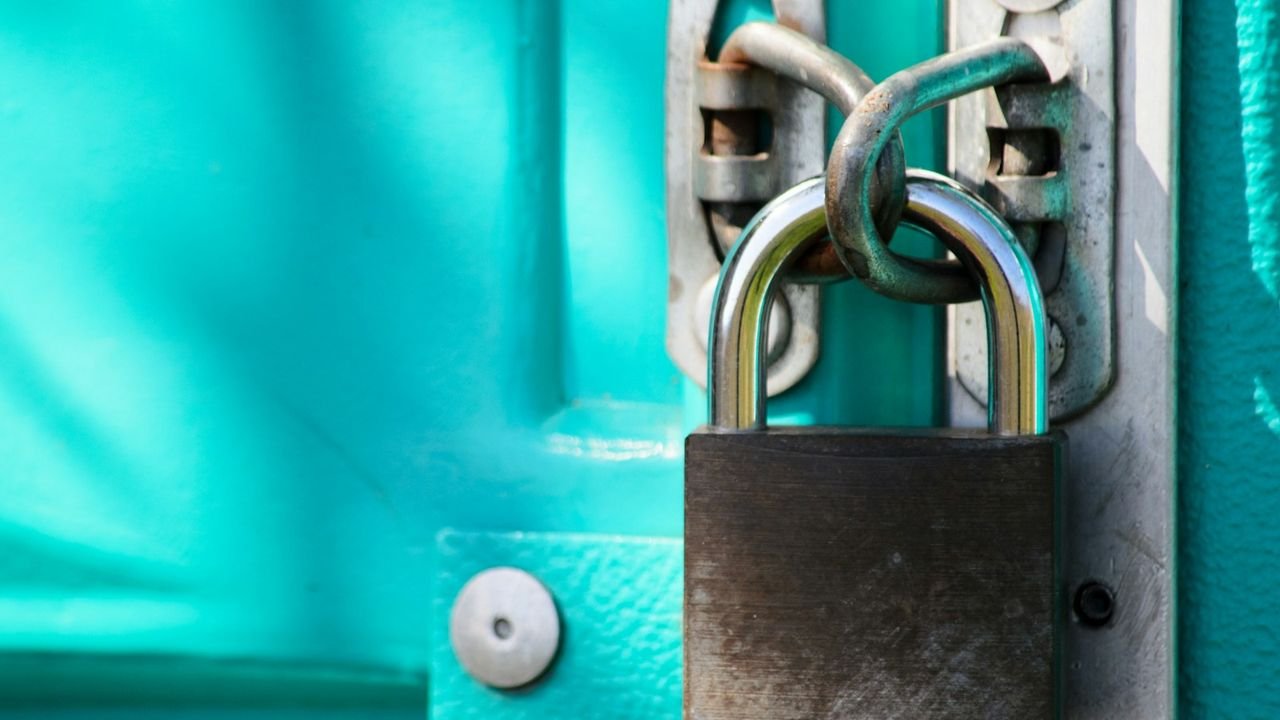Close-up of a padlock on a door, representing a lockout