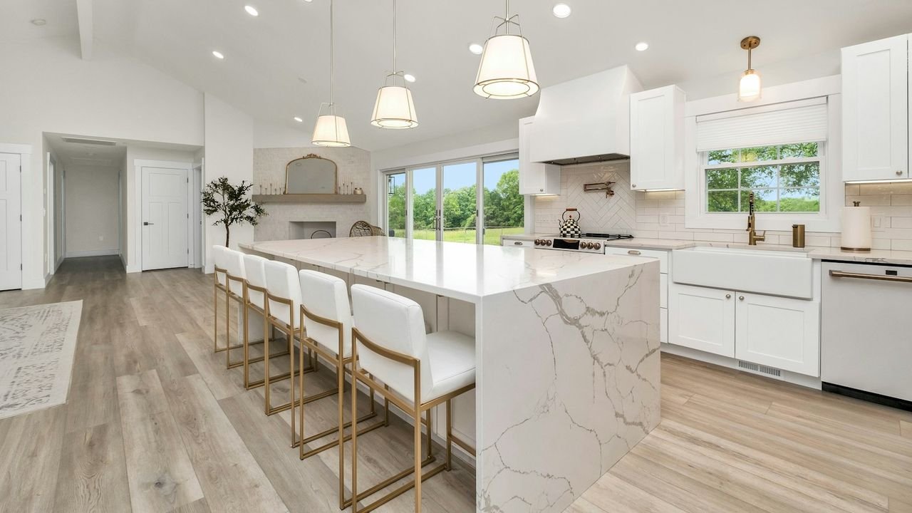 Spotless kitchen with a marble island and white cabinets