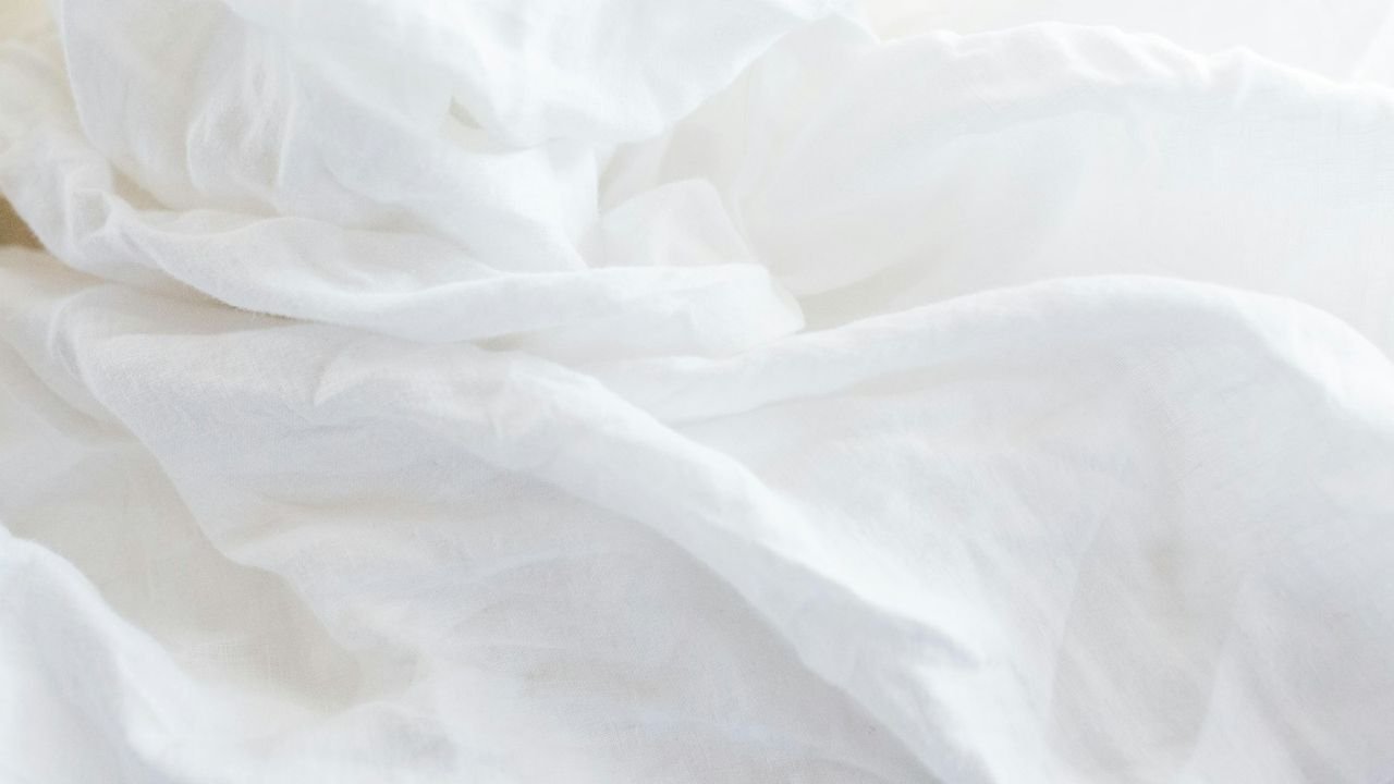 Freshly made bed with crisp white sheets