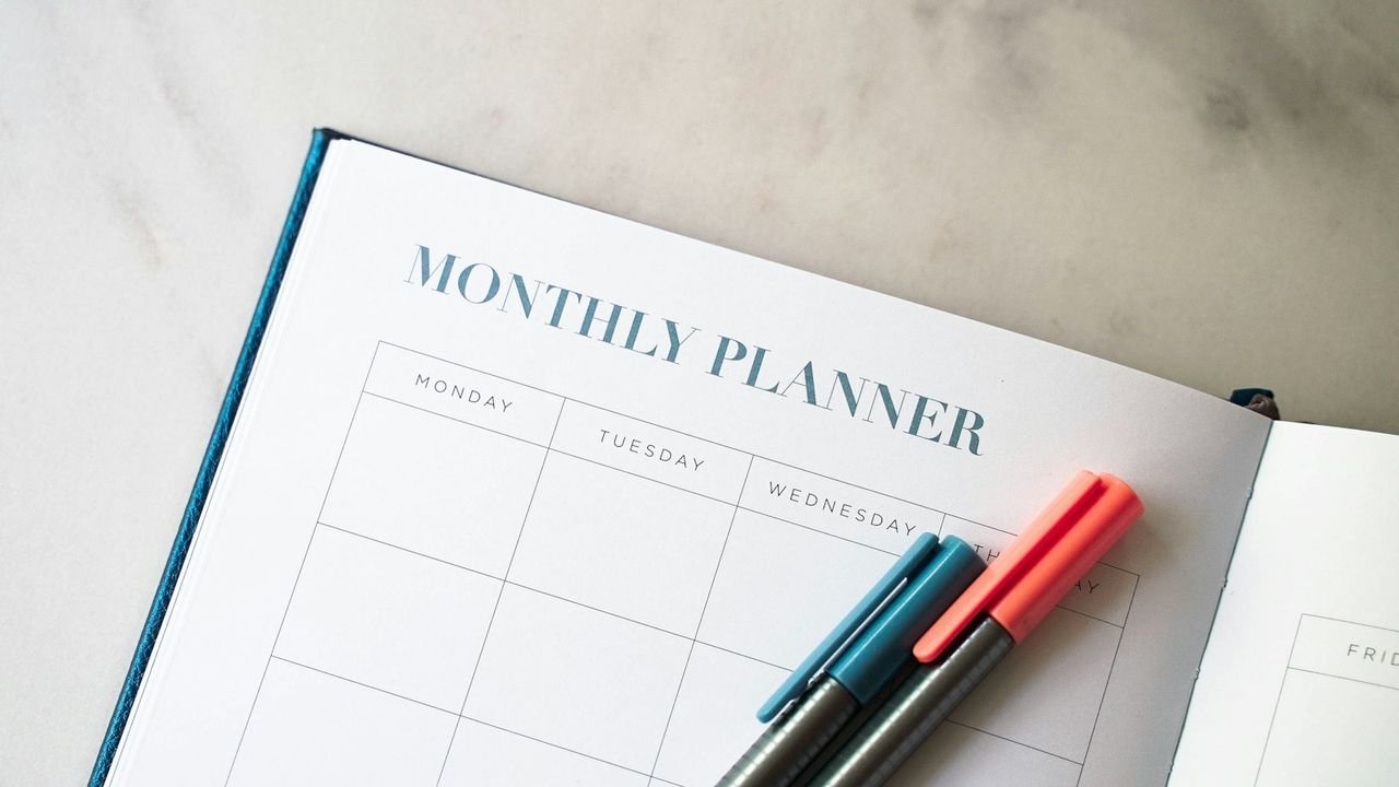 Planner and pens for mapping out an advertising budget
