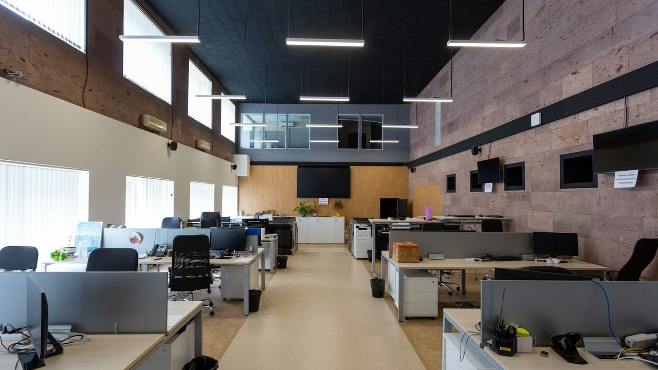 Open-plan office with rows of desks to be cleaned