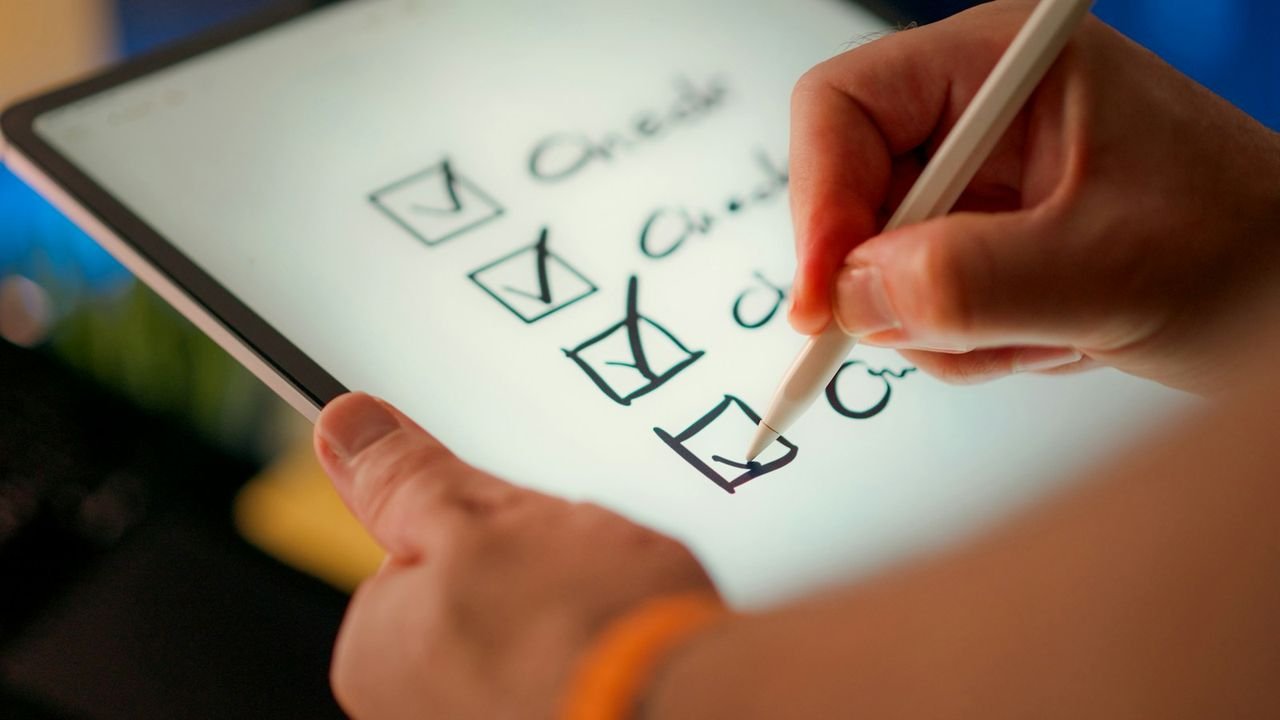 Hand ticking off items on a checklist