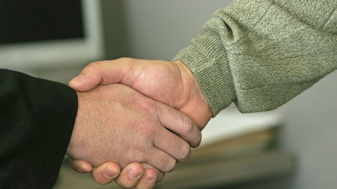 Close-up of two people shaking hands