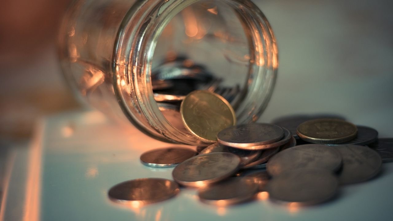 Glass jar of coins, representing client lifetime value